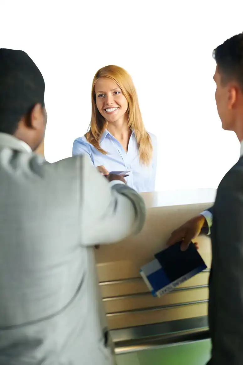 Two people shaking hands and a third one watching